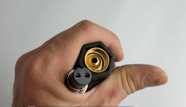 WP-26 TIG torch power connector and control plug, close-up in hand